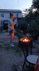 Evening backyard gathering with cooking and cat in Viadana