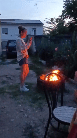 Evening backyard gathering with cooking and cat in Viadana