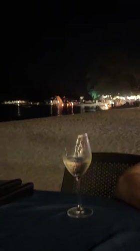 Beachside dining and playful dog captured at Thai restaurant