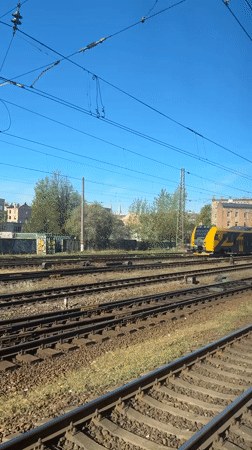 Passenger train travels through Riga railway system early morning