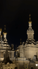 Golden-domed Orthodox cathedral lit up at night in Saint Petersburg