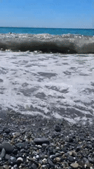 Sunny day swimming at Sochi's rocky Black Sea shore