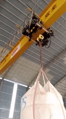 Crane lifting bulk bags at a Malaysian construction site