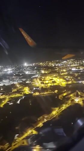 EasyJet passenger views illuminated Matosinhos cityscape during night flight