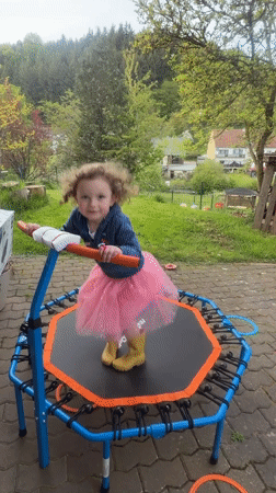 Child plays on backyard trampoline in German village