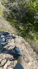 Hiker stands on rock outcrop in Bulgarian countryside