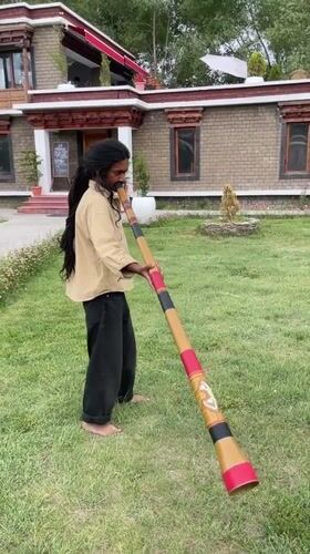 Didgeridoo played in a Leh courtyard with Tibetan architecture