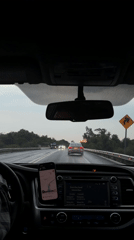 Driver navigates wet highway near Zacatelco using phone GPS