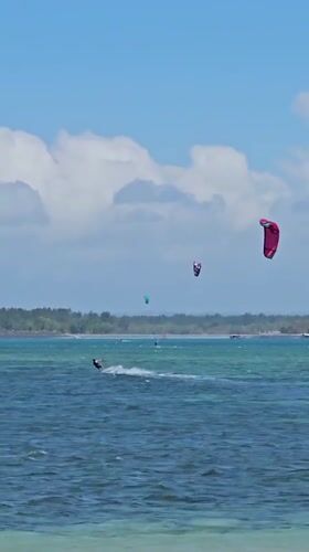 Kitesurfers take over a Bali beach on a sunny afternoon