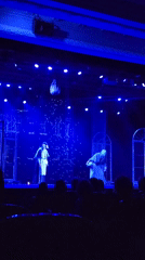 Moscow theater performance features dramatic blue lighting, period costumes