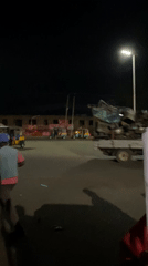 Nighttime street market bustles with vendors and diners in Bukuru