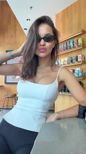 Woman poses with beverage at Shanghai Starbucks