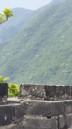 Morning visit to Great Wall features paragliders overhead
