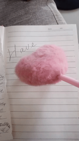Person writes encouraging message in notebook in North Kuta
