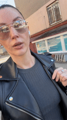 Woman records selfie video while walking Perm sidewalks