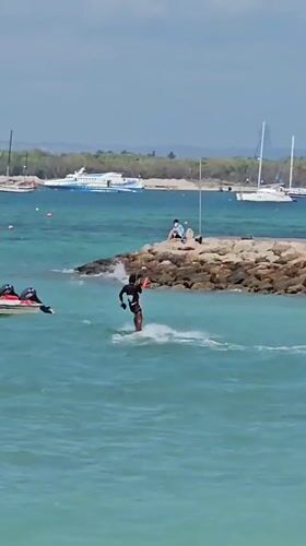 Kitesurfer hits aerial tricks off the Bali coast