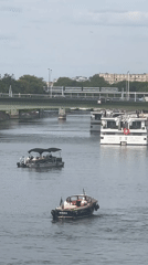 Boat traffic on the Seine with the Eiffel Tower in view