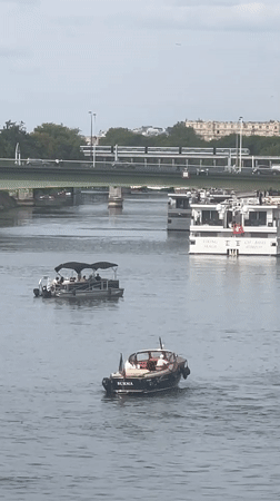 Boat traffic on the Seine with the Eiffel Tower in view