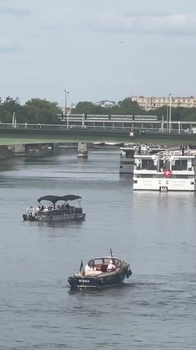 Boat traffic on the Seine with the Eiffel Tower in view