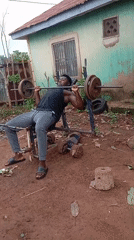 Man conducts outdoor weightlifting session in Akwanga, Nigeria