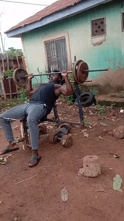Man conducts outdoor weightlifting session in Akwanga, Nigeria