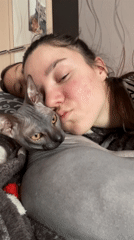 Woman and hairless cat share quiet morning in snowy Russian village