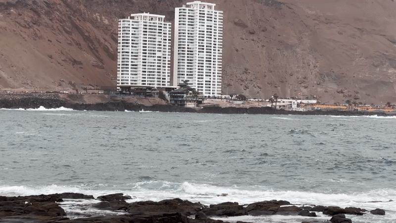 Arica's rocky Pacific coastline under cloudy skies