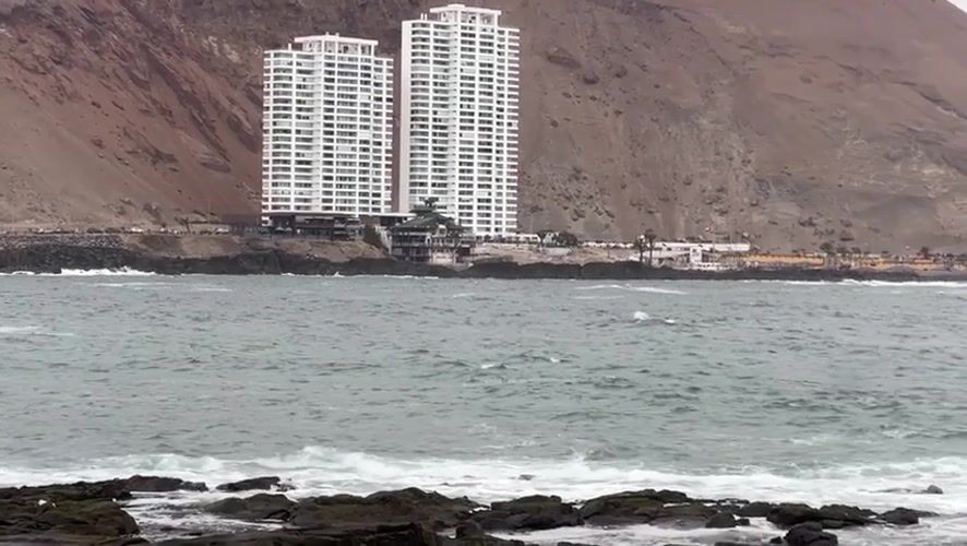 Arica's rocky Pacific coastline under cloudy skies