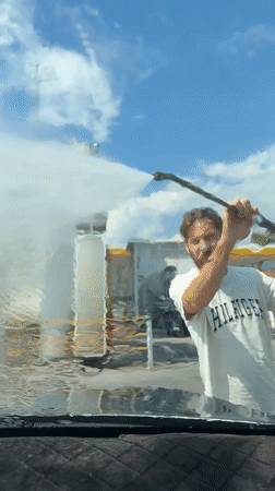 Man washes car at self-service station in Fethiye
