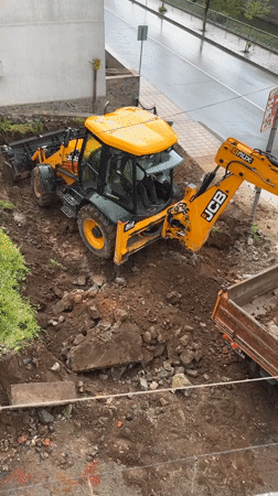 Construction crew loads dirt truck in Zlatograd, Bulgaria