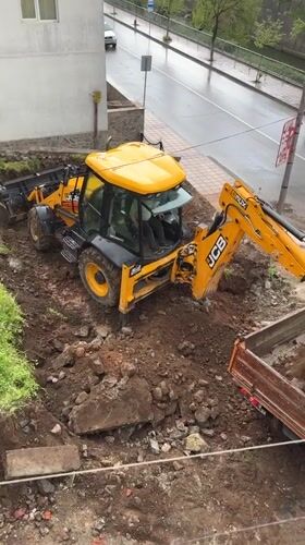 Construction crew loads dirt truck in Zlatograd, Bulgaria