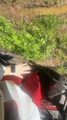 Motorcycle rider stuck in mud near Ilyinsky, Russia