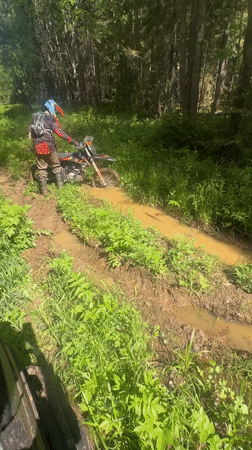 Motorcycle rider stuck in mud near Ilyinsky, Russia