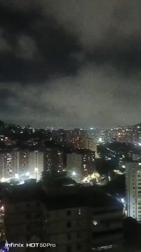 Caracas nighttime cityscape captured under cloudy skies early morning