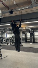 Man exercises at London gym doing pull-ups and push-ups