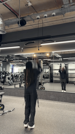 Man exercises at London gym doing pull-ups and push-ups