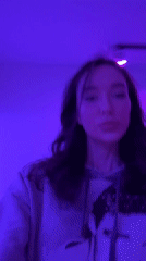 Woman records purple-lit selfies in Moscow apartment