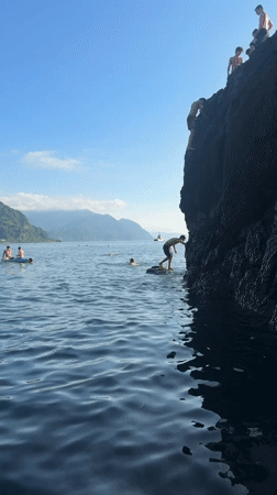 Cliff jumping into calm blue water at Sarpi's beach