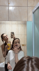 Women Apply Makeup, Take Selfies in Kragujevac Bathroom