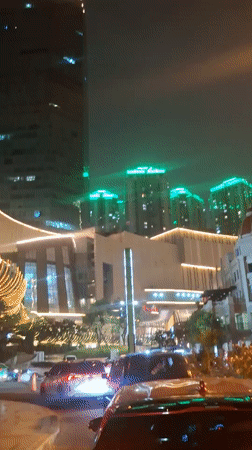 West Jakarta's towers and streets glow on a busy night