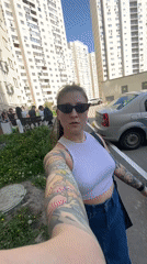 Person walks sidewalk in Saratov wearing casual clothing