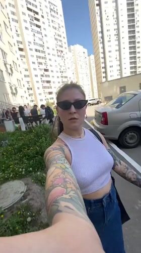 Person walks sidewalk in Saratov wearing casual clothing