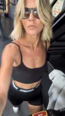 Woman in athletic wear walks through Mengwi gym