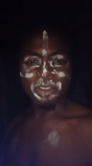 Cultural gathering with face paint, children documented in Ogidi