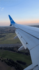 Passenger films airplane wing over Spanish countryside near Madrid