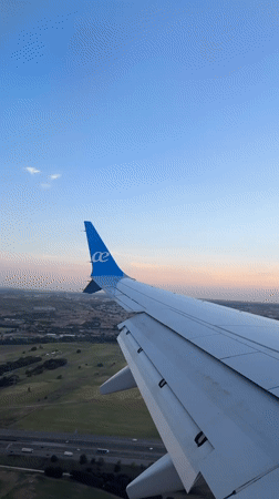 Passenger films airplane wing over Spanish countryside near Madrid