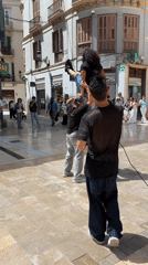 Street acrobats perform handstand stunt in Málaga square