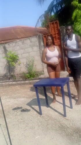 Two people gather at outdoor table in Lagos