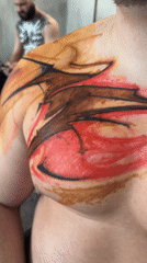 Man displays colorful temporary tattoos in Moscow room