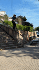 Young man rides scooter down stairs in Spanish town